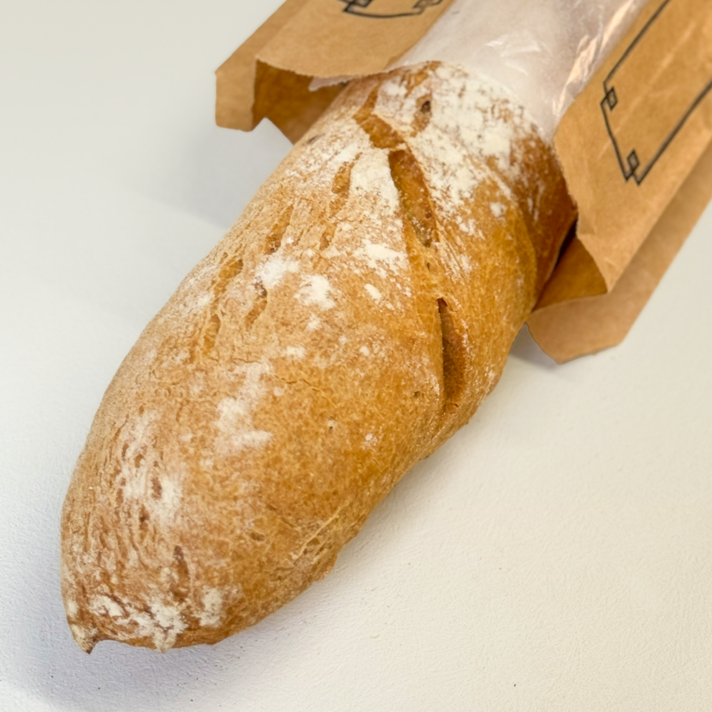 Freshly baked gluten-free baguette from Happy Atelier Stockholm with a golden crust and fluffy interior.